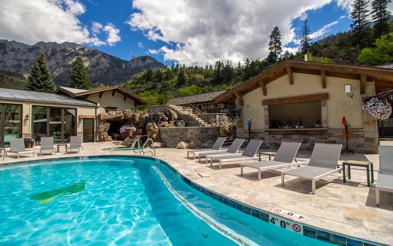 Mineral soaking tubs and outdoor pool at Ouray CO Hotel & Hot Springs by Twin Peaks, a hot springs hotel in Ouray, Colorado